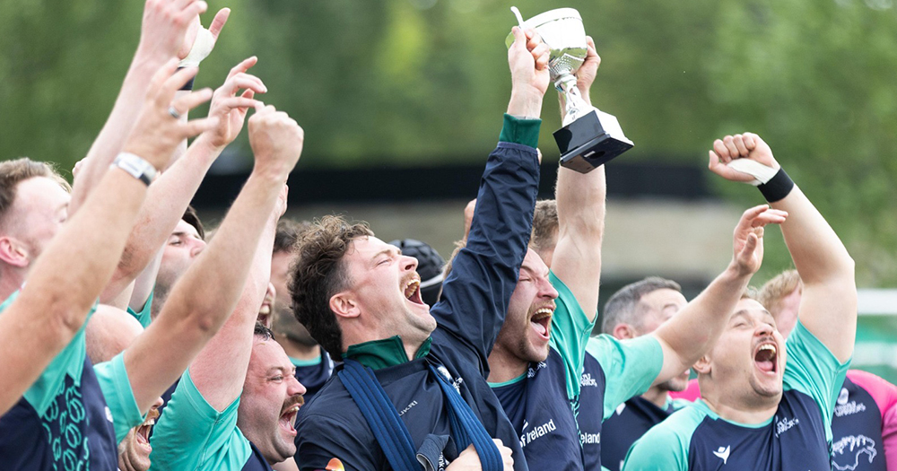 Members of the Emerald Warriors rugby club on the field as they celebrate winning the Union Cup.