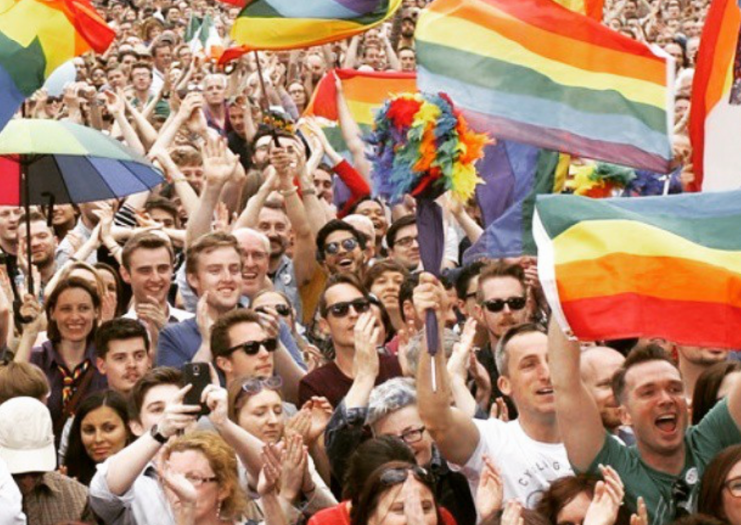 Participants wave rainbow flags at the 2015 parade.
