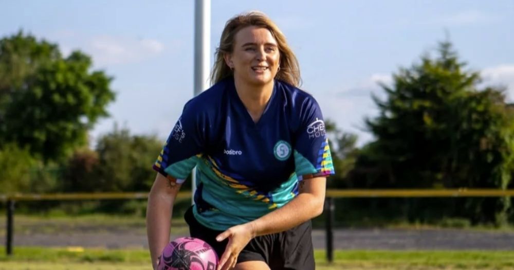 Sarsfields Rugby player Sarah Lynch, whom the Lynch Cup is in honour of, in action holding a rugby ball.