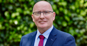 A portrait photo of Garda Representative Association president Mark O'Meara wearing a suit and glasses.