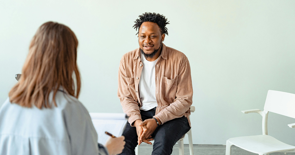 This article is about a new guidance for mental health services in Ireland. In the photo, a person speaking to a therapist.