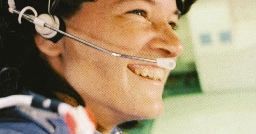 Profile shot of Sally Ride in space suit with headset on.