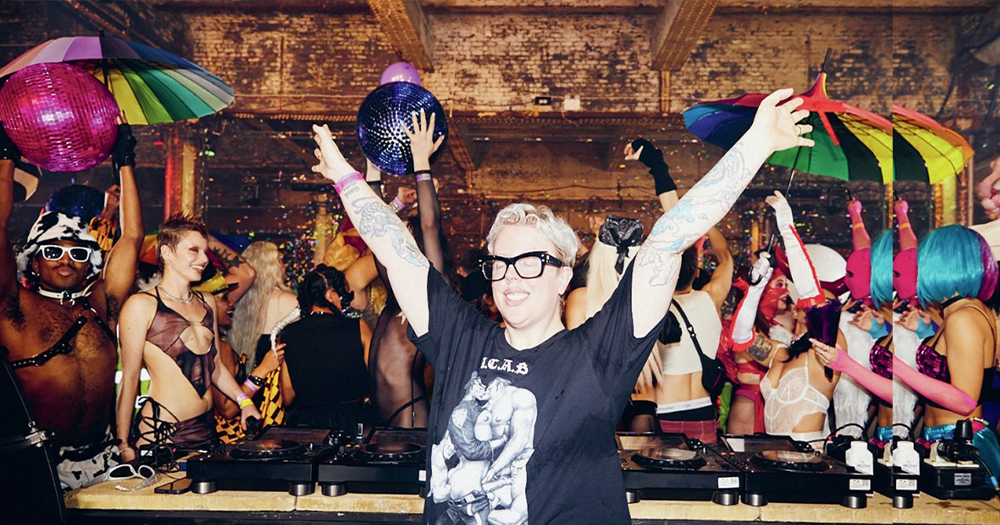 Image shows The Blessed Madonna at a gig arms outstretched