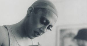 A black and white still of Anziety in a wig cap.