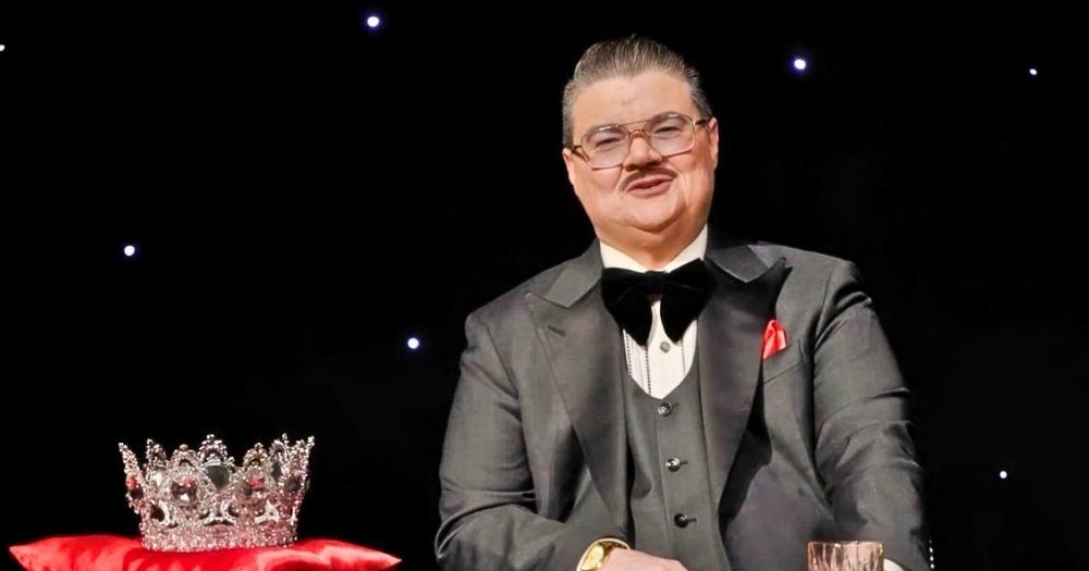 Drag king Murray Hill, who hosted King of Drag and recently announced its winner, talking to the camera with a crown beside him.