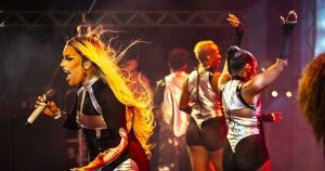 Photo of Gloria Groove performing at a concert.