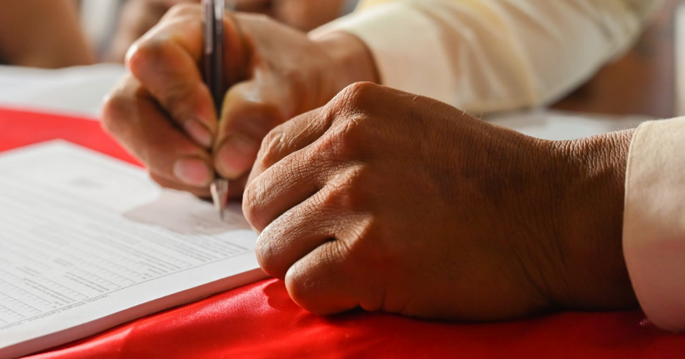 Image shows a petition being signed - Activists have created a petition to the Minister for Health demanding a reform on transgender healthcare in Ireland.