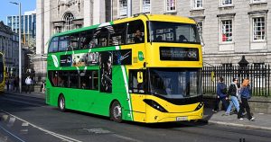 This article is about charges for incitement of hatred relating to a homophobic assault. In the photo, a green and yellow Dublin bus driving in front of Trinity College Dublin.