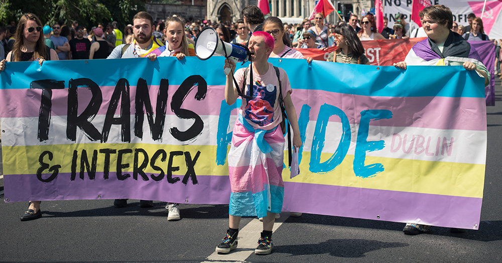 An image of activist Ollie Bell at Trans & Intersex Pride. In this article, they talk about gender recognition and trans rights in Ireland.