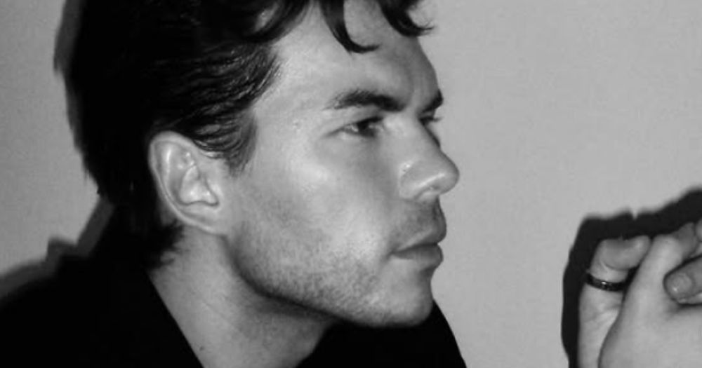 Luke Newton, who has been cast to play Alexander McQueen, posing for a black and white photo.