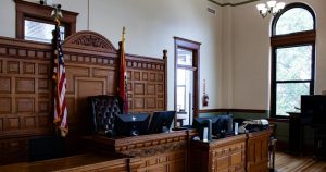 This article is about Virginia allowing forms of conversion therapy. In the photo, a court displaying US flags.