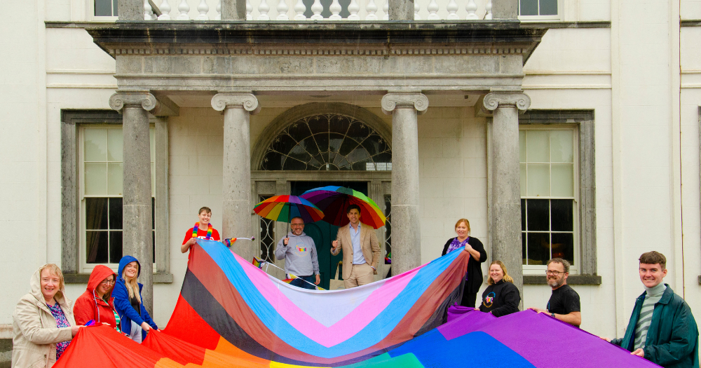 Roscommon Pride organisers holding a pride flag.