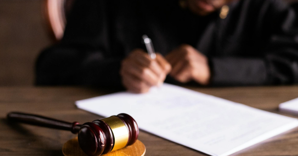 Image shows legal paperwork being signed - A gay Nigerian man has been granted permission from to re-apply for asylum after new evidence emerged of the severe dangers he faces at home.