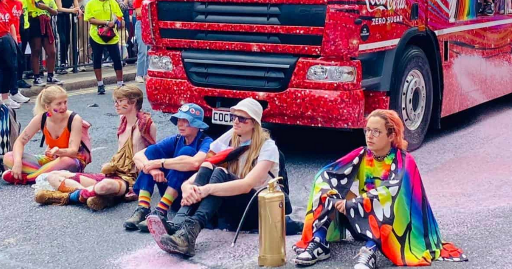 Image shows members of the climate action group Just Stop Oil protesting at London Pride 2023.