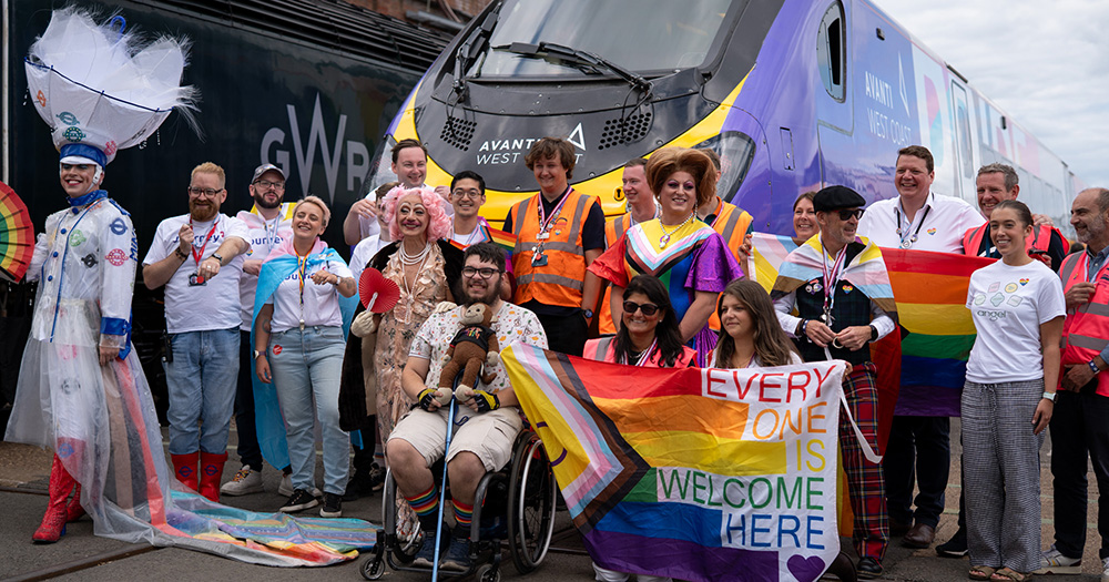 Participants of the world's first Pride parade on a train pose for a photo outside one of the carriages.