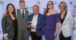 The organisers of Q Con, Ireland's queer women's+ sexual health conference, posing with their GALAS award.