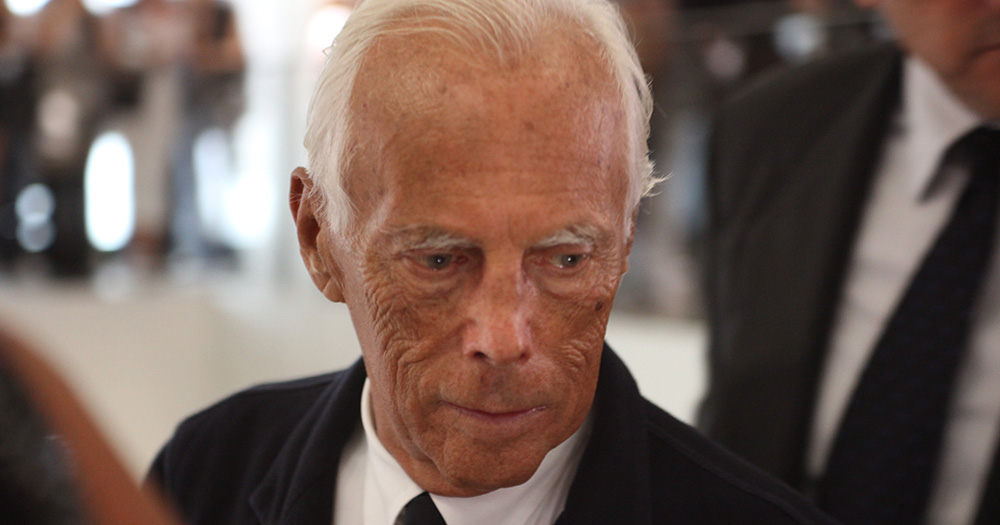 Close up of Giorgio Armani looking down.