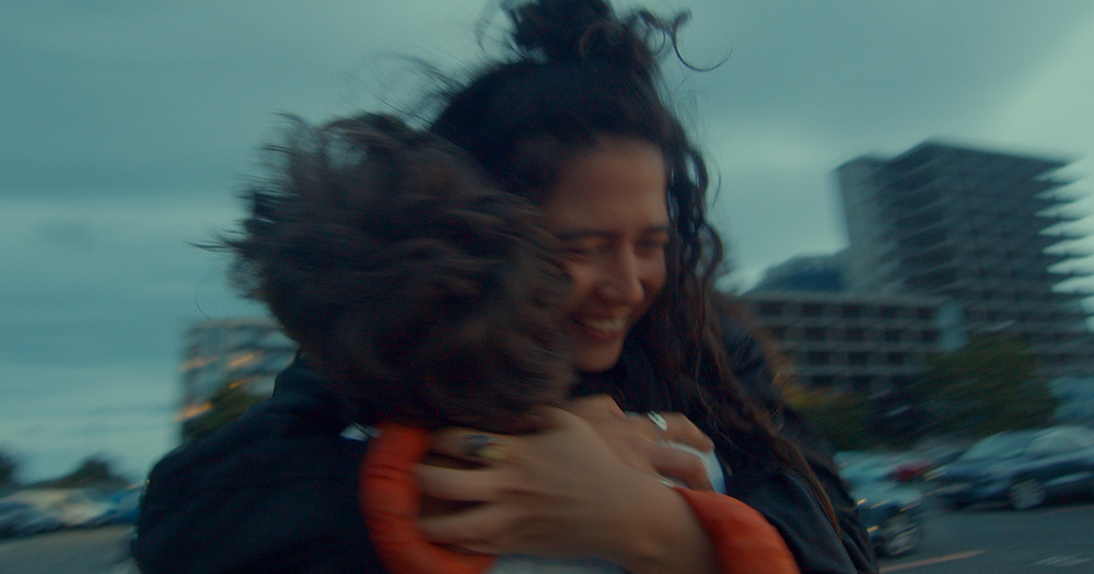 Promo image for new queer play Attention showing two people hugging.