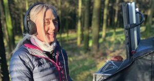 Bea O'Sullivan working as a sound mixer at an outdoor shoot.
