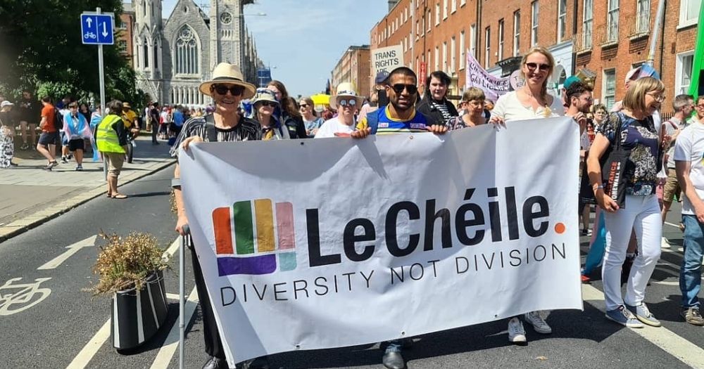 This article is about the Diversity Carnival Against Racism. In the photo, people marching in Dublin with a banner that reads Le Chéile - Diversity not Division.