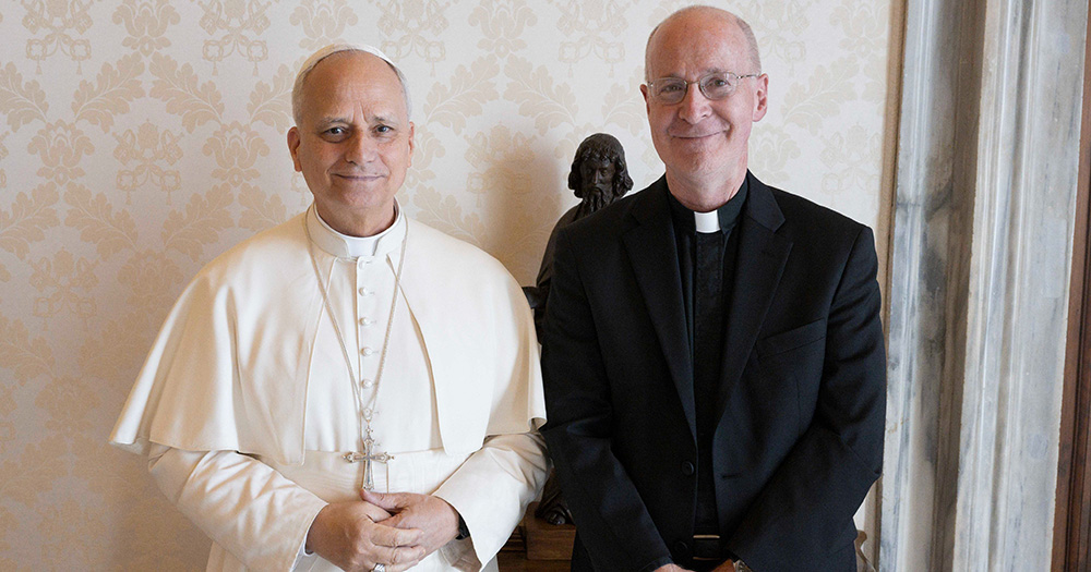 Pope Leo and LGBTQ+ advocate Fr James Martin smiling for a photo.