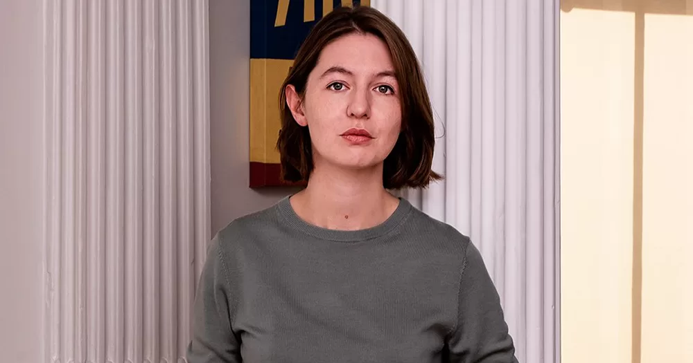 Irish author Sally Rooney, who has pledged to support Palestine Action, leaning on a wall and looking at the camera.