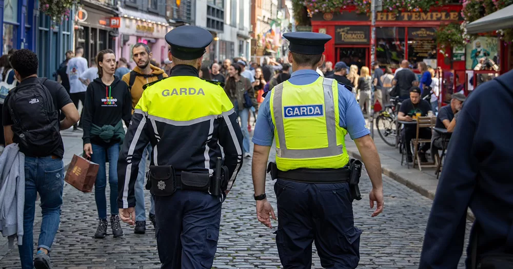 This article is about a woman experiencing homophobia and racism from teenagers in Ireland. The image shows to Gardaí walking through Temple Bar in Dublin.