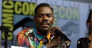 Colman Domingo sits at a Comic Con panel.
