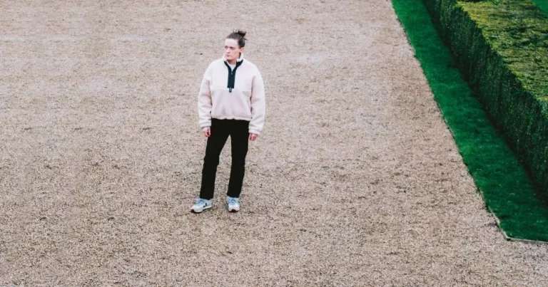 Elaine Mai stands in the middle of a wide garden path.