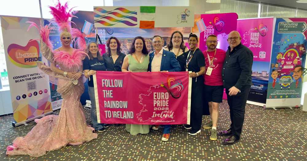 Members of the West of Ireland coalition who won a bid to host EuroPride 2028 posing for a picture and holding a banner.