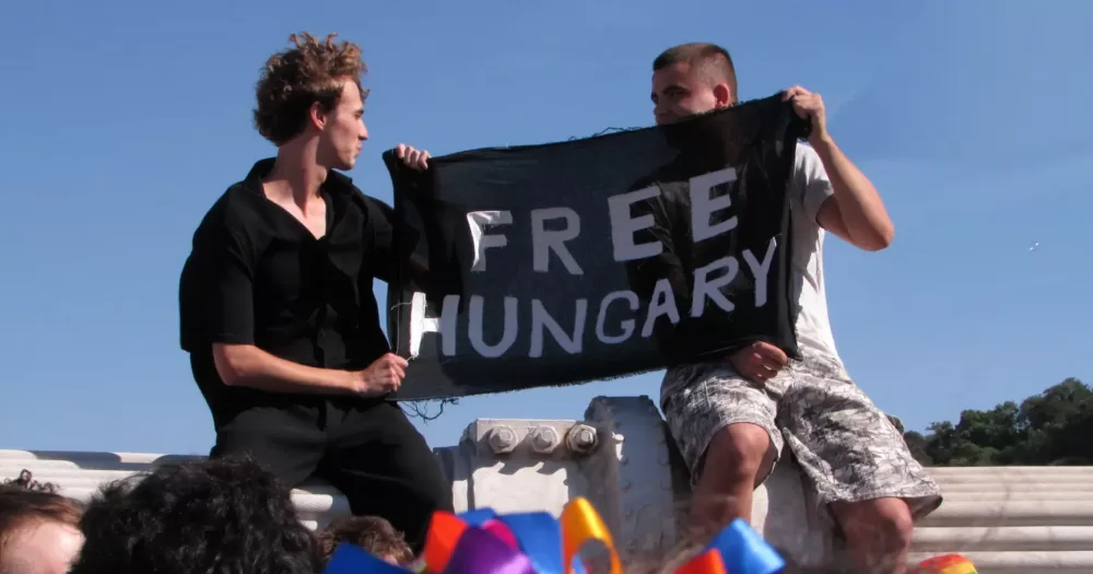 Two people hold a sign that reads 'Free Hungary' - in response to the ban of Pécs Pride