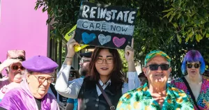 Image shows members of the Queensland community protesting against puberty blocker bans