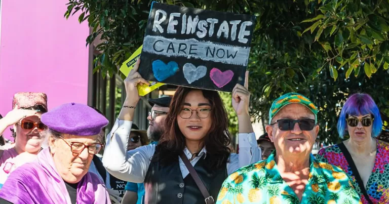 Image shows members of the Queensland community protesting against puberty blocker bans