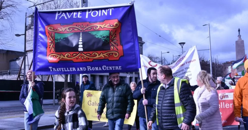 Pavee Point community members hold placard -Travellers and Roma in Ireland are experiencing severe and persistent inequalities, according to new EU data