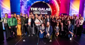 A large group of award recipients on stage at The GALAS 2025 ceremony.