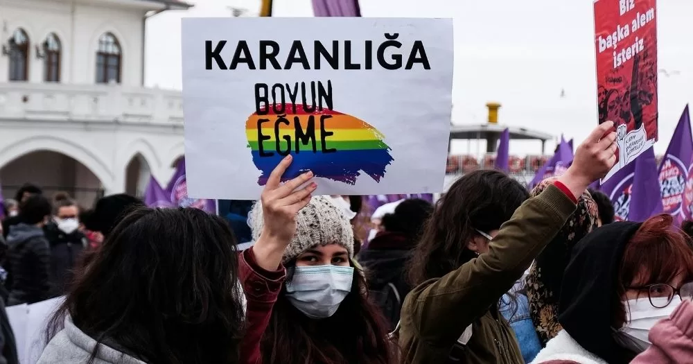 At a protest for LGBTQ+ rights in Türkiye, a protester holds a sign in Turkish that translates to 
