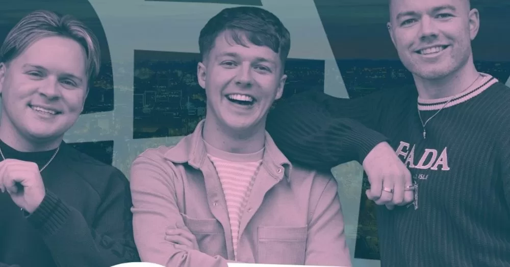 The hosts of Gay Linn podcast stand side by side, smiling.