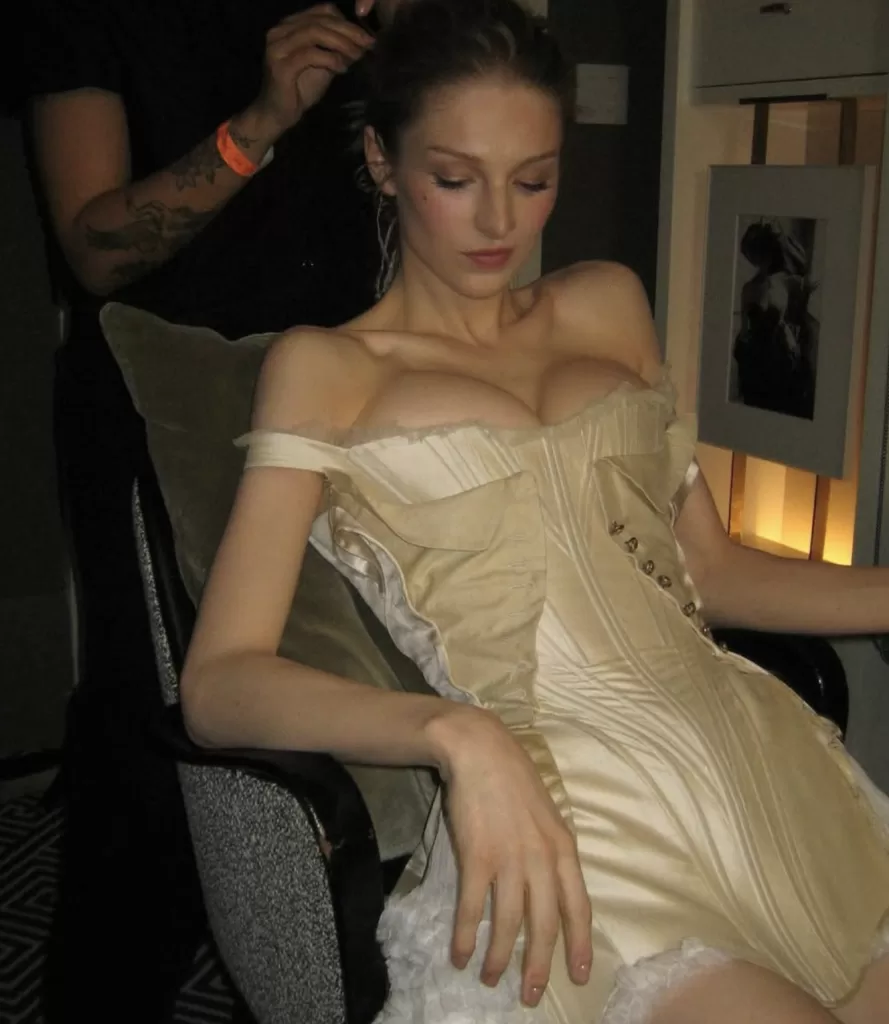 Hunter Schafer dressed in a golden corset dress.