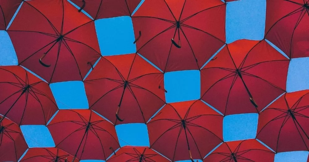 The image shows a series of red umbrellas against a blue sky. The photo is taken from below. Ireland's sex worker festival is organised by the Red Umbrella Éireann collective.