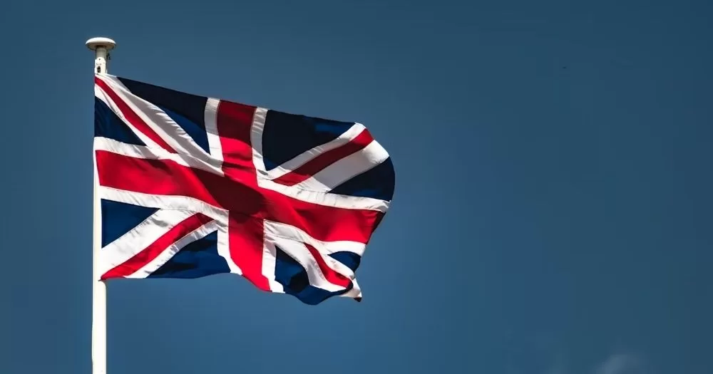 This article is about the Council of Europe Commissioner discussing human rights in the UK. A UK flag flying with the sky in the background.