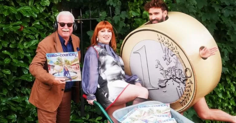 Image shows Marty Whelan, CMAT and Irish musician Púca wearing a giant Euro costume posing with a wheelbarrow full of CMAT's records. This image accompanies an article about the biggest LGBTQ+ stories from 2025.