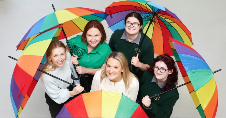 Young people hold rainbow umbrellas, Belong To is launching its Stand Up Awareness Week 2025
