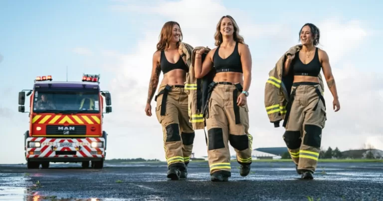 Some of the women invloved in the firefighter calander pose together with a truck nearby