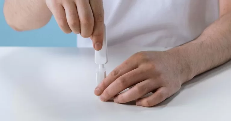 A pair of hands holds a HIV at home self-test, the kind that is delivered through Grindr.