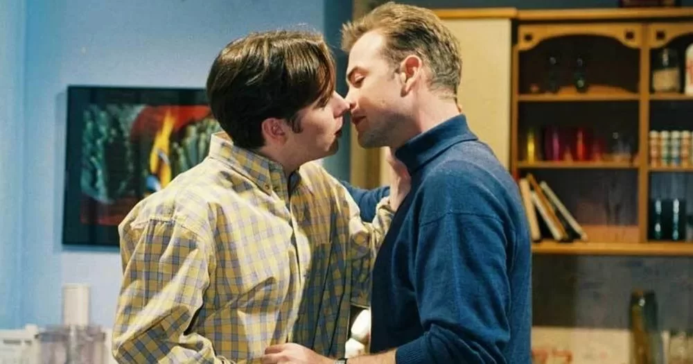 Two men lean in to kiss during a scene in Fair City. This image is being used to accompany an article about the TV's first same-sex kisses.