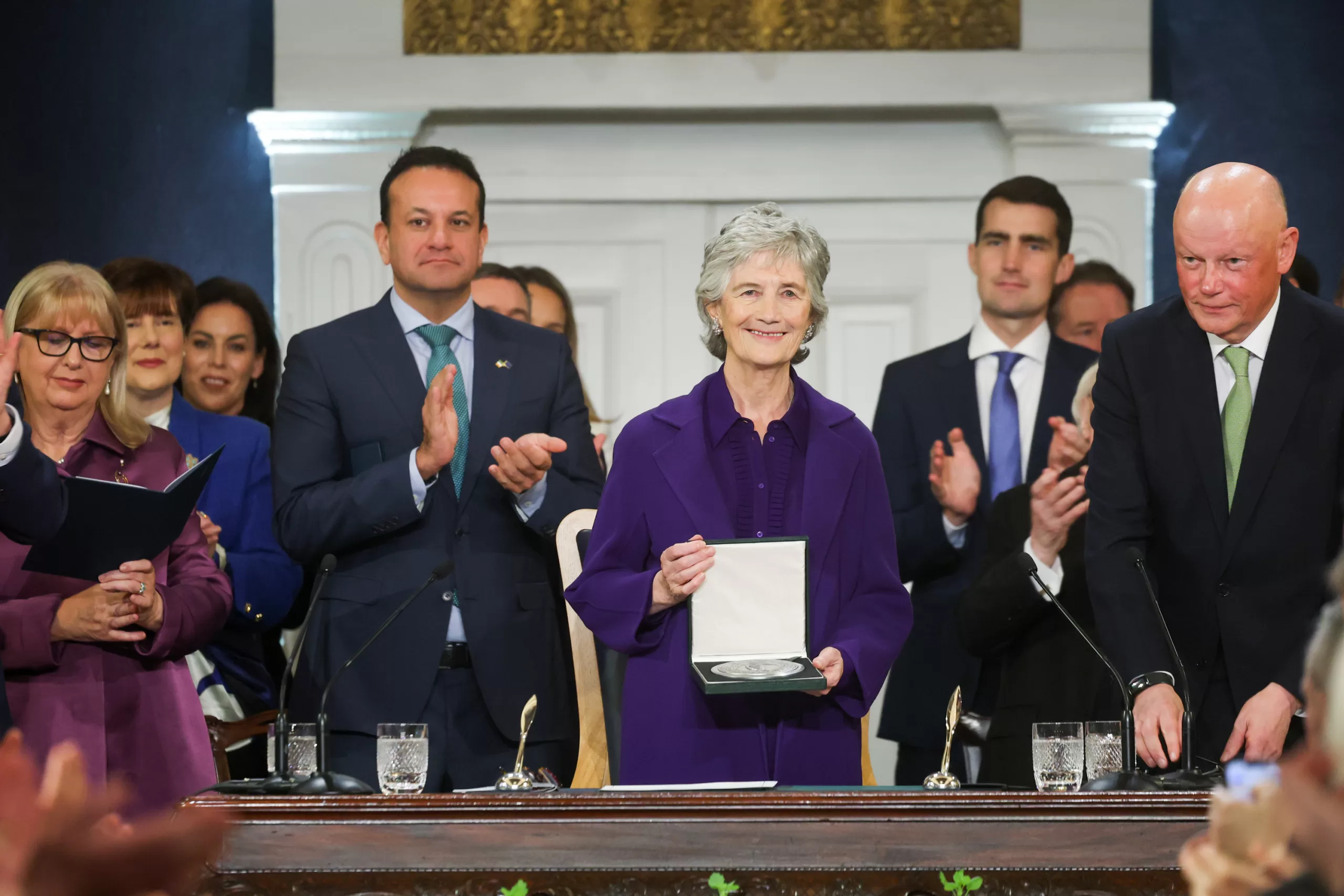 Catherine Connolly is inaugurated as President of Ireland and is surrounded by politicians. 