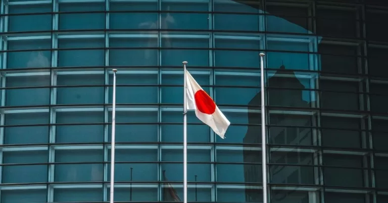 A Japanese flag in fornt of a building. This image is being used to accompany an article about Japan's same-sex marriage ban.