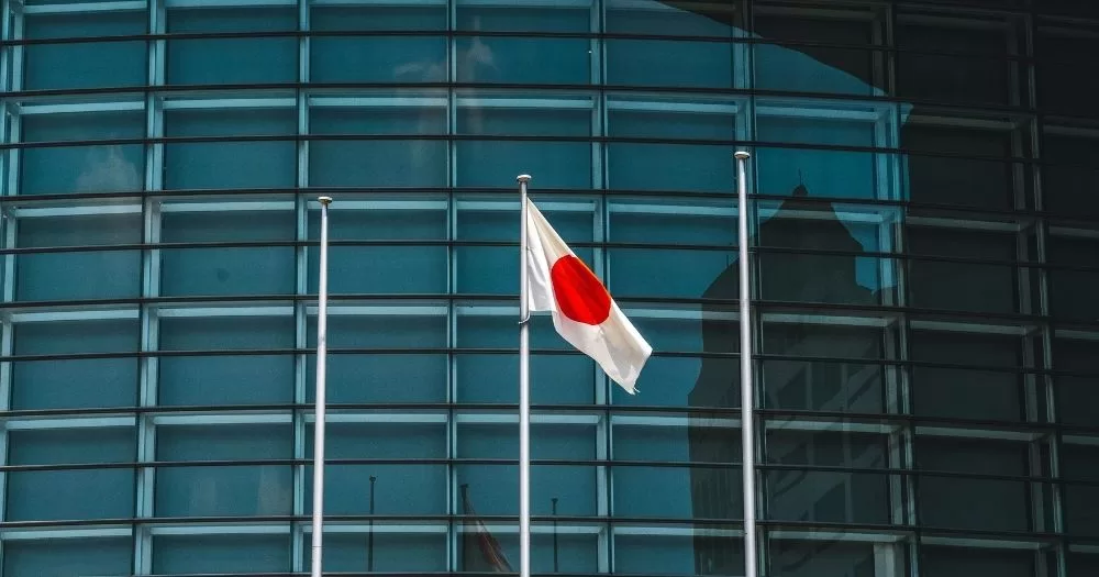 A Japanese flag in fornt of a building. This image is being used to accompany an article about Japan's same-sex marriage ban.
