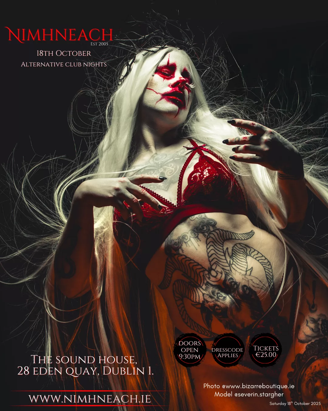 A model poses. She wears a red bra and her torso is covered in tattoos.