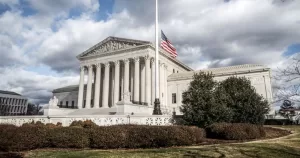 US Supreme Court, which has recently refuse a challenge to the ruling legalising same-sex marriage, with a US flag flying in front of the building.